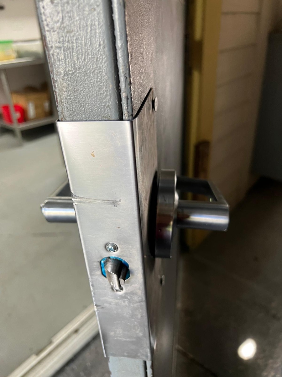 Heavy-duty deadbolt and lever on a commercial kitchen door