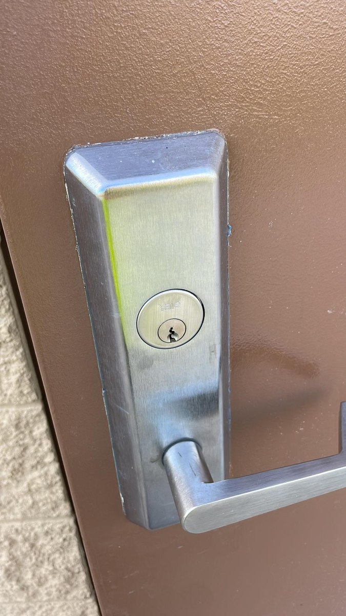 Commercial-grade mortise lock and lever on a steel door