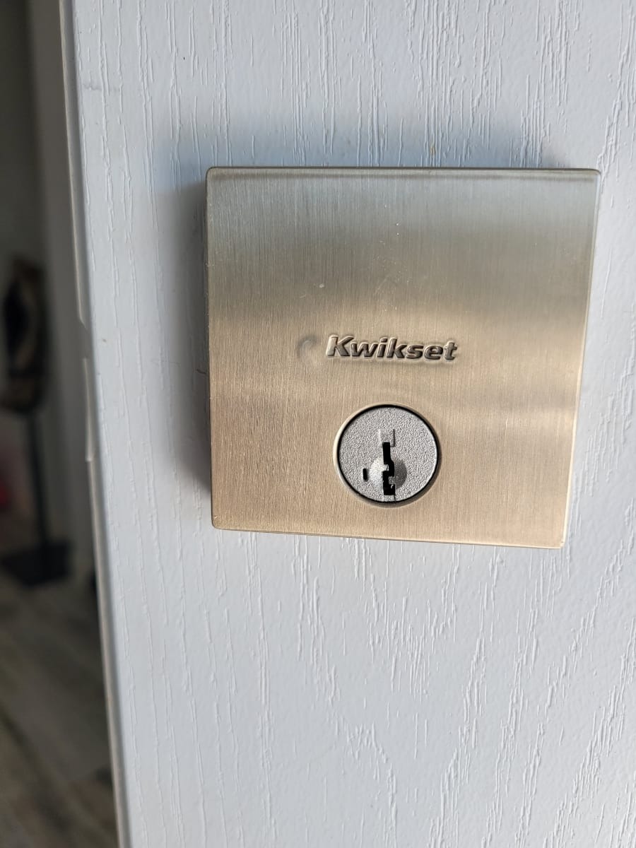 New Kwikset contemporary deadbolt installed on a front door