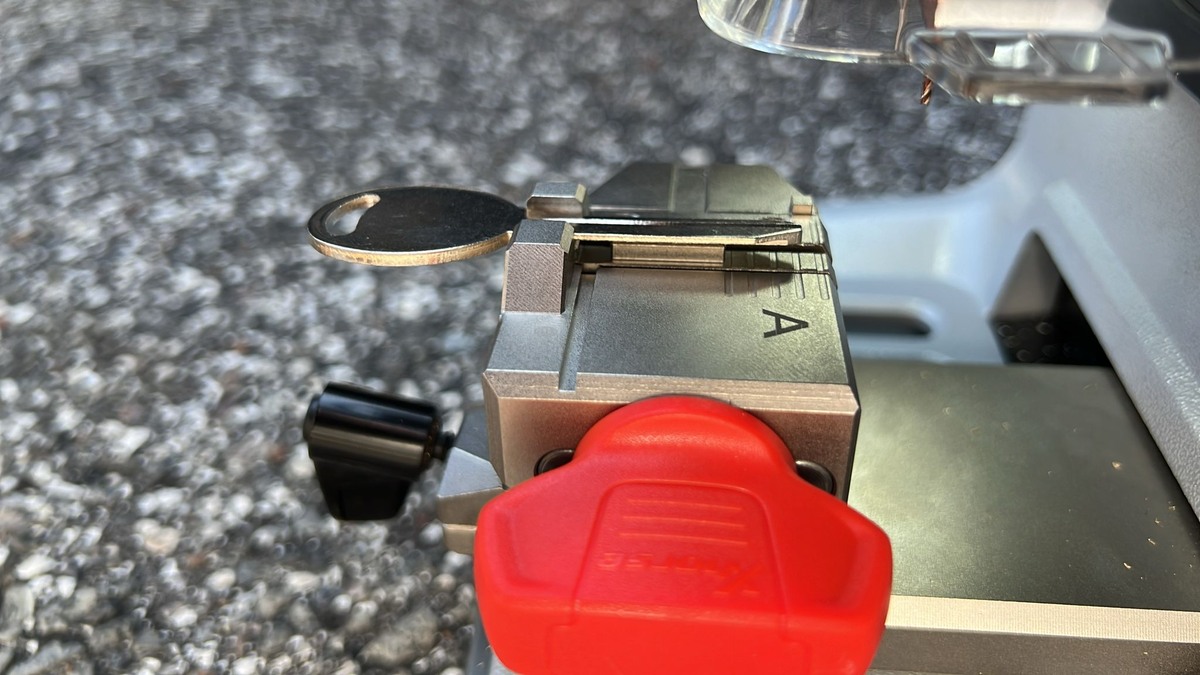 Portable key machine cutting a key on the truck tailgate