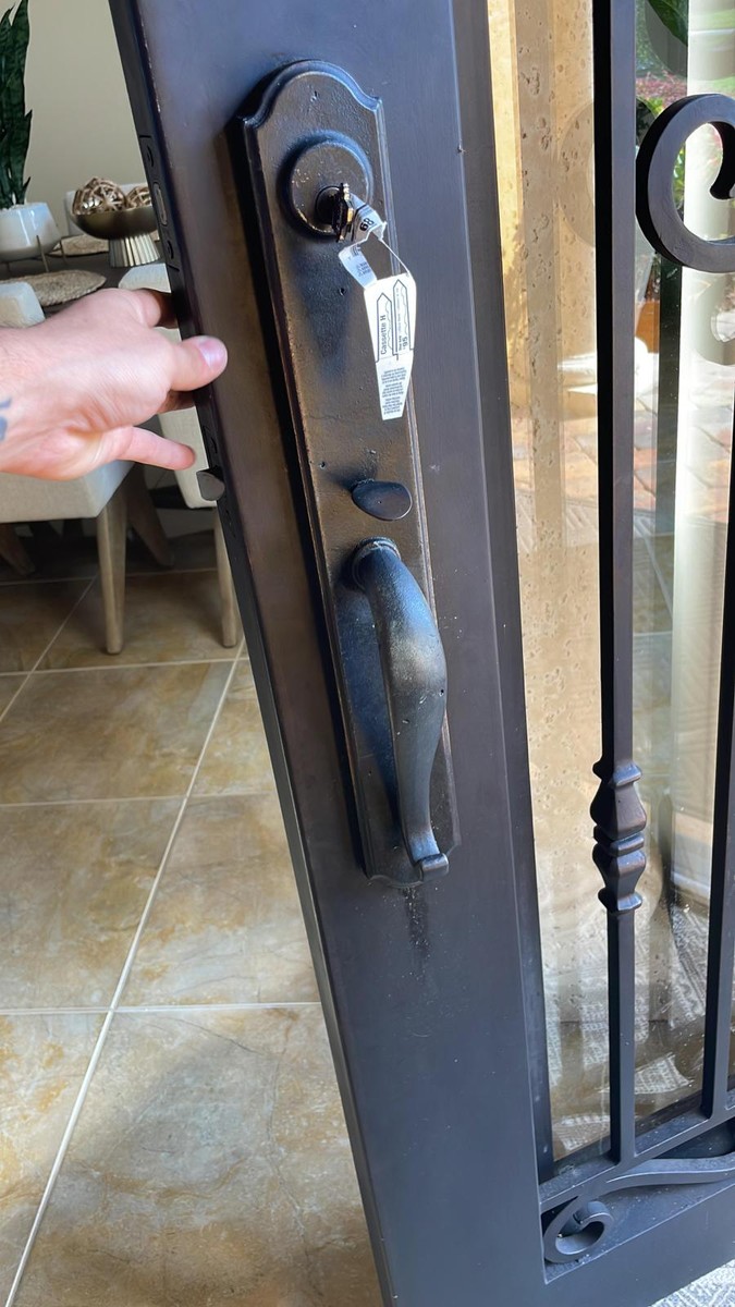 New handleset with key on an iron-and-glass entry door