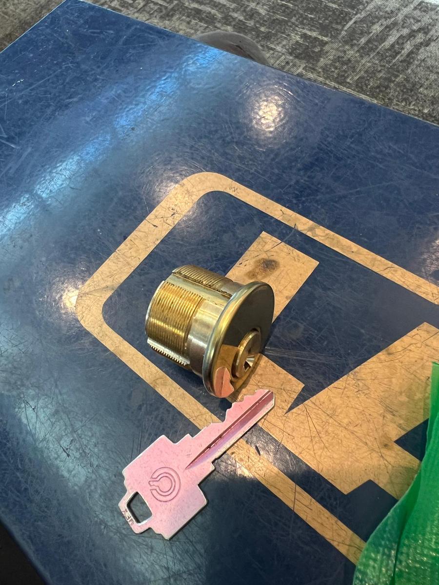 Mortise cylinder and new key on the workbench