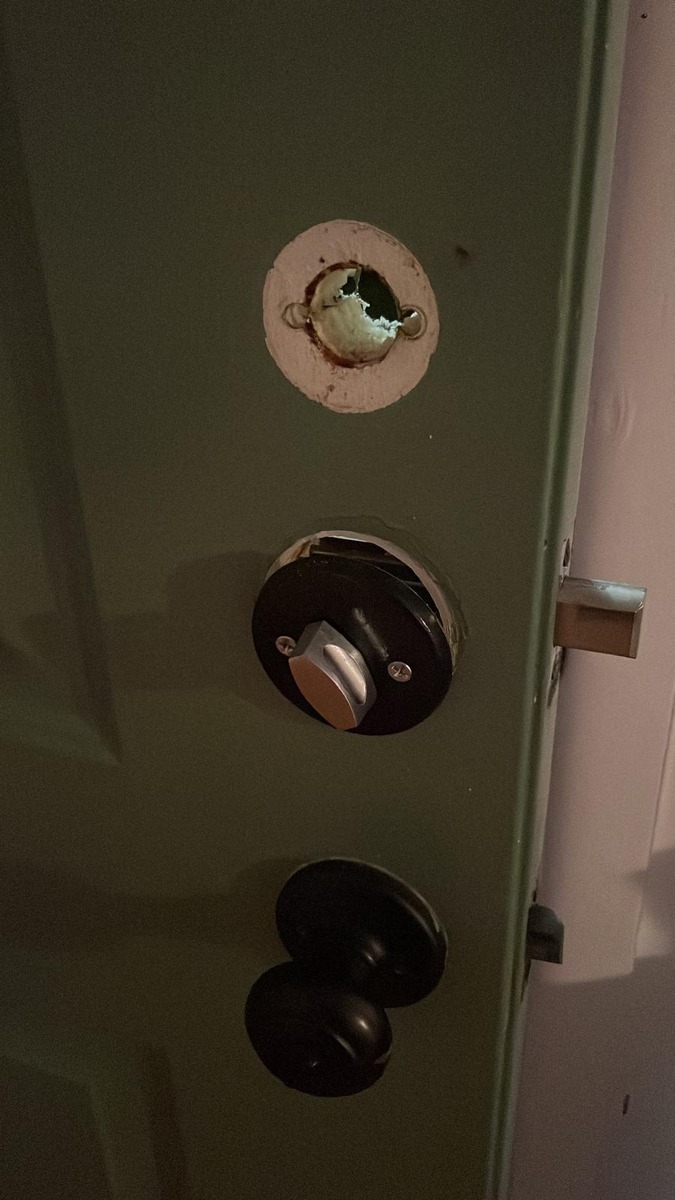 Fresh deadbolt installation with thumb turn on a green door