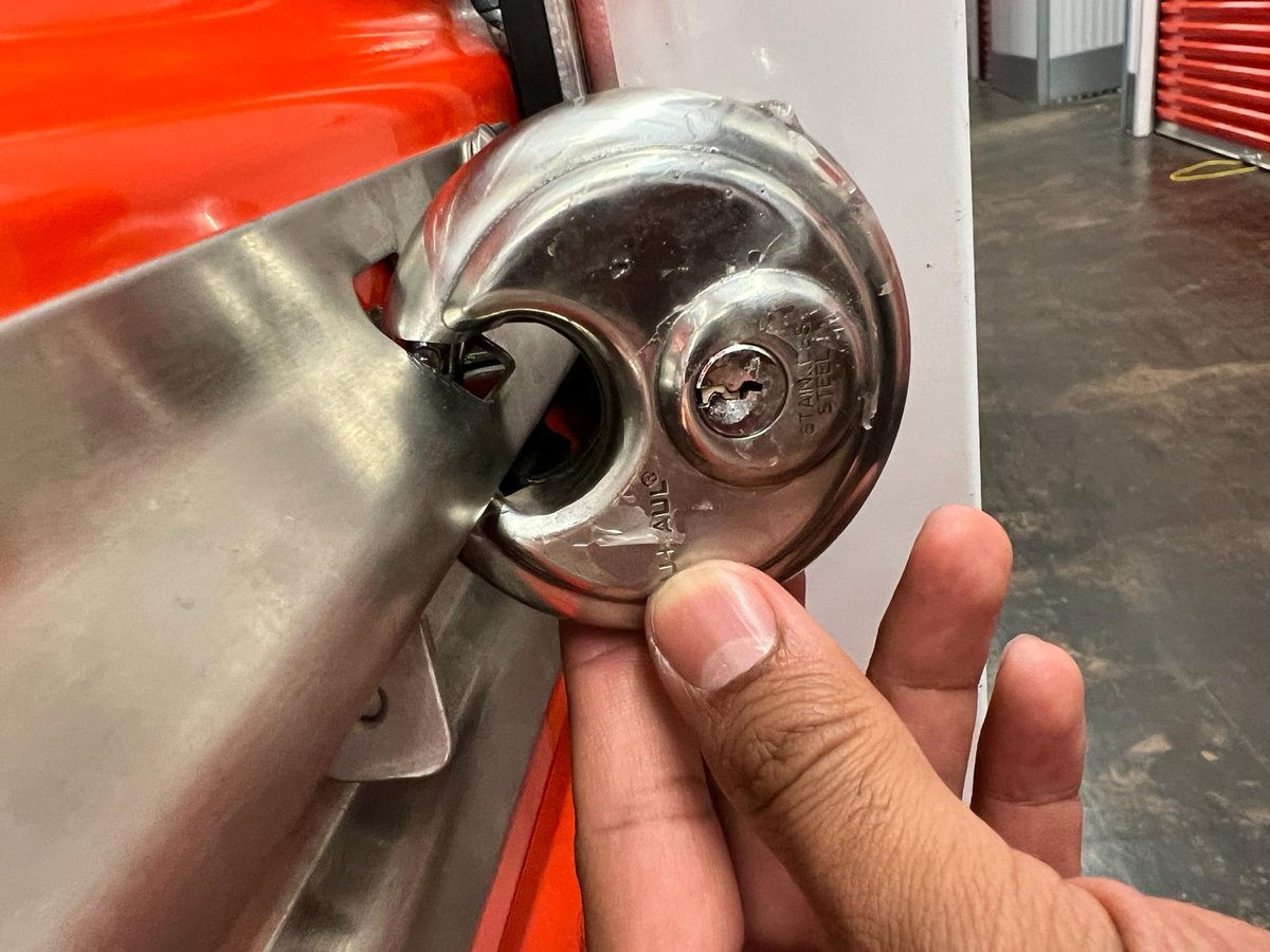 Removing a disc padlock from a storage unit latch