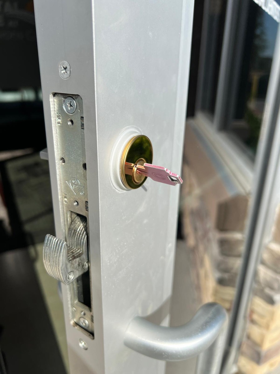 Unlocking a storefront hook-bolt lock on an aluminum door